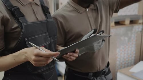 Two People Working In Warehouse