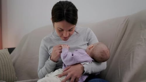 Loving Mother Holding Her Newborn Baby