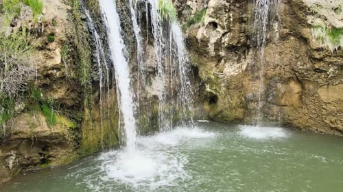 Waterfall Flowing into a Pool of Water