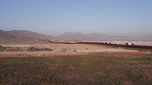 Border Construction with Mountain Backdrop