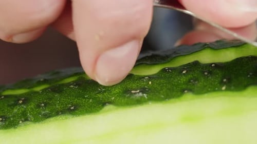 Close Up View of a Cucumber Being Peeled