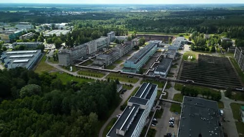 Modern Industrial Complex Surrounded By Greenery Viewed From Above Shows a Harmonious Relationship