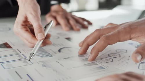 Business People Discussing Charts and Graphs
