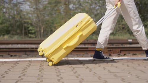 Adult Walks with Suitcase on Railway Platform