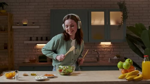 Happy Woman Making Salad in Cozy Kitchen