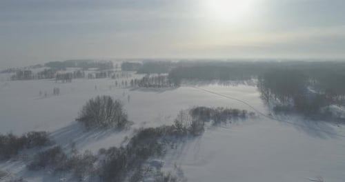 Aerial View of Cold Winter Landscape Arctic Field Trees Covered with Frost Snow Ice River and Sun