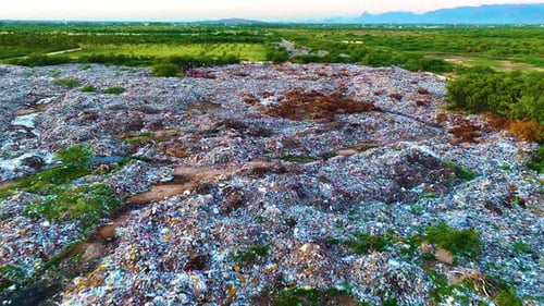 Garbage Dump With Dirty Water - Aerial View By a Drone Backwards