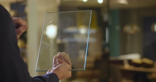 Image for graphic implements. Close up of a hand that uses a glass tablet to control the lights of