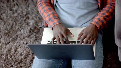 Adult Typing on Laptop at Home During Day