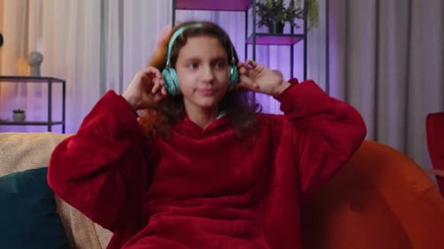 Girl Listening Music with Headphones on Couch
