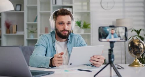 Man Filming Himself Working from Home on Tablet