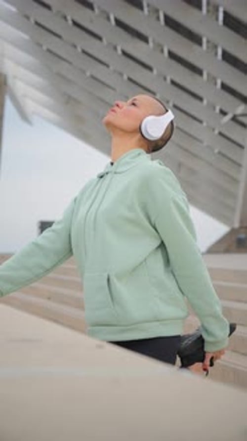 Athletic Woman Stretching Leg in an Urban Setting
