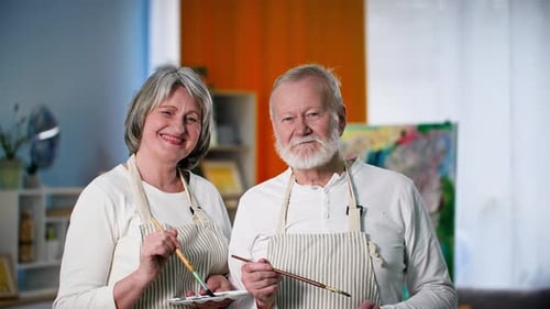 Smiling Senior Couple Ready to Paint Together