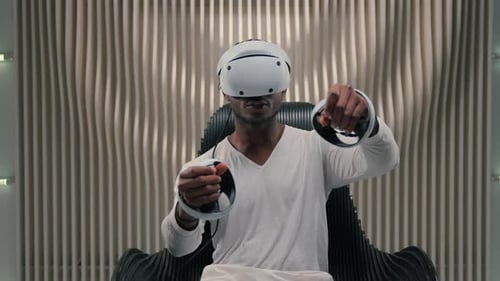 Man Enjoys Virtual Reality Gaming with Modern Headset
