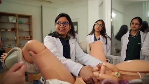 Medical Student Demonstrates Birthing Simulation to Classmates