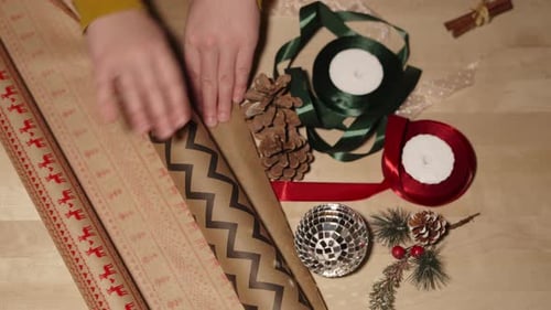 Woman Unfolds Eco Craft Paper with Hand to Decorate Gifts Top View