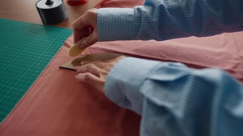 Woman Marking Fabric with Chalk and Template