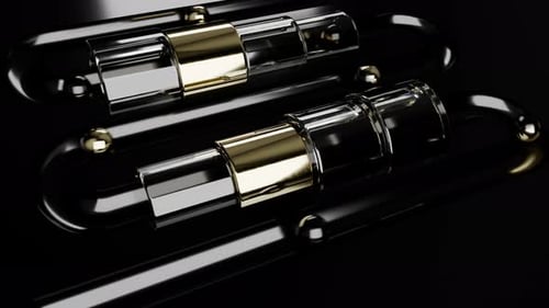 Black and Gold Metal Balls Rolling on Track Through Tunnel Loop