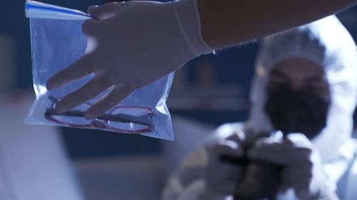Forensic Scientist Photographs Evidence at Crime Scene