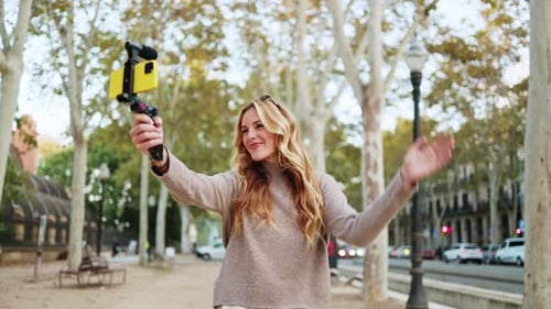 Young Woman Vlogging in Urban Park with Smartphone