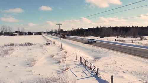 Aerial pullback shot of snowplow truck cleaning snow on the highway after snowstorm, Brampton, Ontar