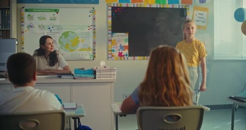 Elementary School Girl Presenting Homework on Ecology in Front of Classmates and Female Teacher