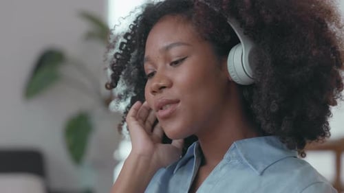 Woman Enjoys Music with Headphones Indoors