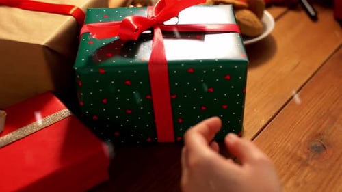 Placing Wrapped Christmas Gifts on Wooden Table
