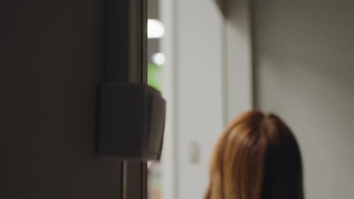 Close Up Light Switch In Dim Corridor As Person Walks Out