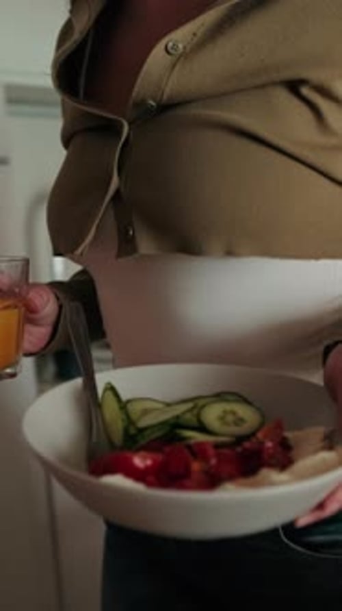Woman Prepares Healthy Salad and Orange Juice