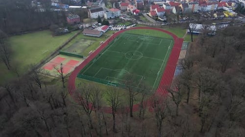 Aerial View of Stadium in Small Town Players Play Football on Soccer Field