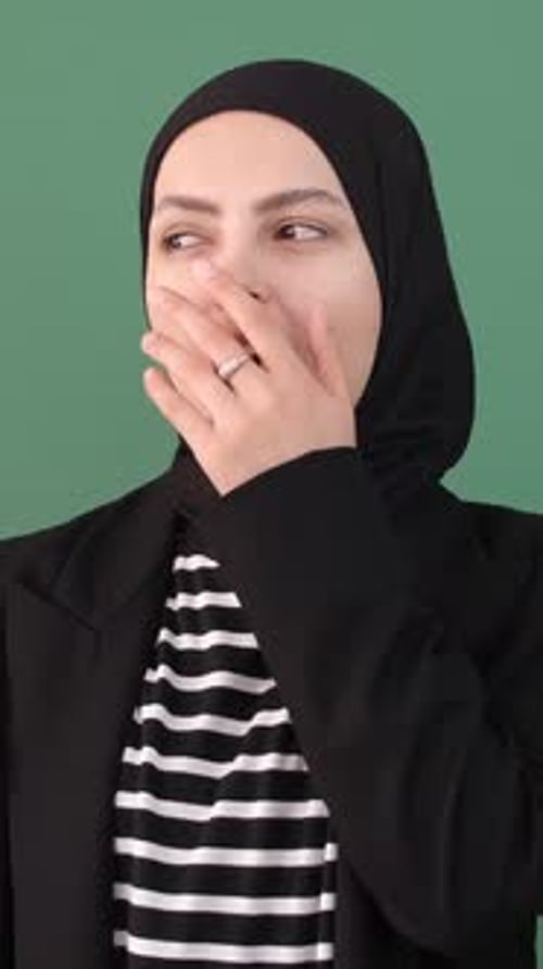 Woman in Headscarf Trying Not to Laugh