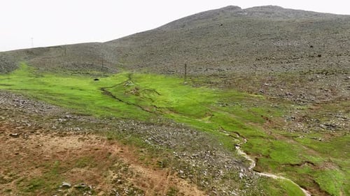 Conquering the Storm Aerial Exploration of a Mountain Plateau and Its Serene Lake in Unforgiving