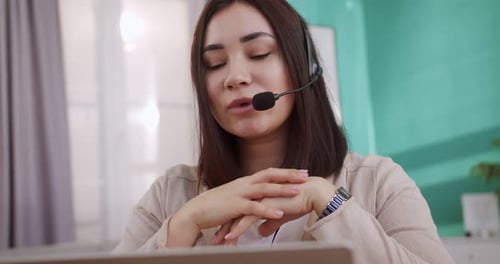 Woman Using Laptop for Video Conference at Home