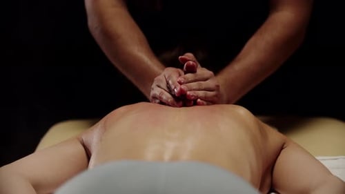 Woman Receiving Massage in Spa Setting