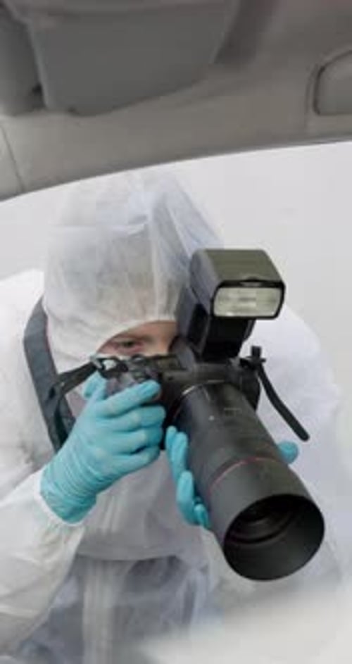 Photographer in Hooded Suit Takes Photos Inside Car