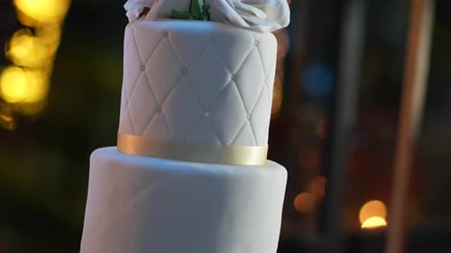 Elegant Wedding Cake with White Roses and Gold Ribbon
