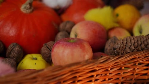 Autumn Harvest Display of Pumpkins and Apples in Basket