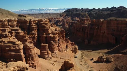 Aerial cinematic shot of the red sedimentary rocks of the Charyn Canyon in Kazakhstan