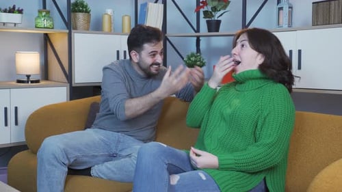 Man and Woman Talking and Smiling on a Couch