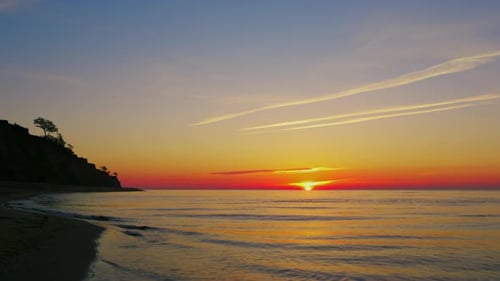 Panorama View Peaceful Ocean Coastline with Mountain Silhouette. Sun Set at Sea