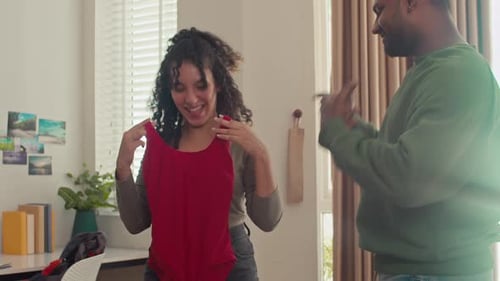 Couple Packing Suitcase for Vacation Together Indoors