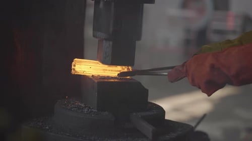 Glowing Hot Iron Being Forged By A Blacksmith In A Metal Workshop