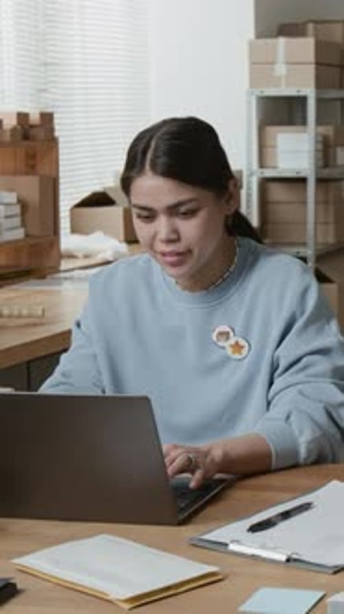 Young Adult Working on Laptop at Office Desk