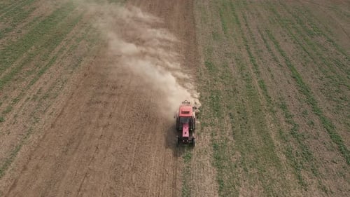 Small Tractor Cultivating Soil at Agricultural Field Aerial View