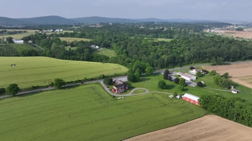 Idyllic and calm city suburb ich farm house and car on intersection. Rural area of America town with