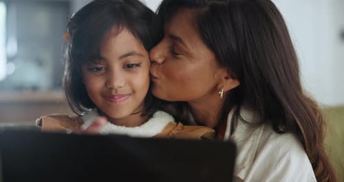 Happy Mother and Daughter Using Tablet Indoors