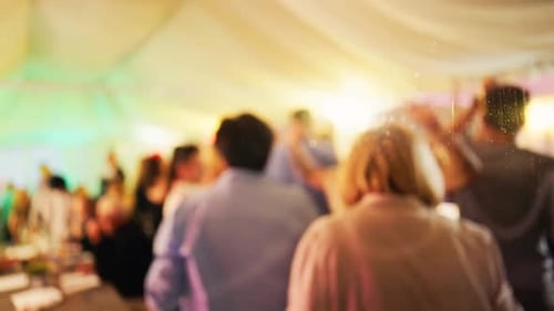 Blurred Partygoers Dancing and Socializing at an Event