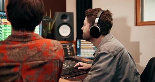Men, artist and music producer in recording studio for sound or audio mixing with equipment