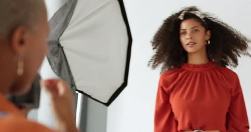 Creative, african and fashion photographer in studio with camera working with trendy